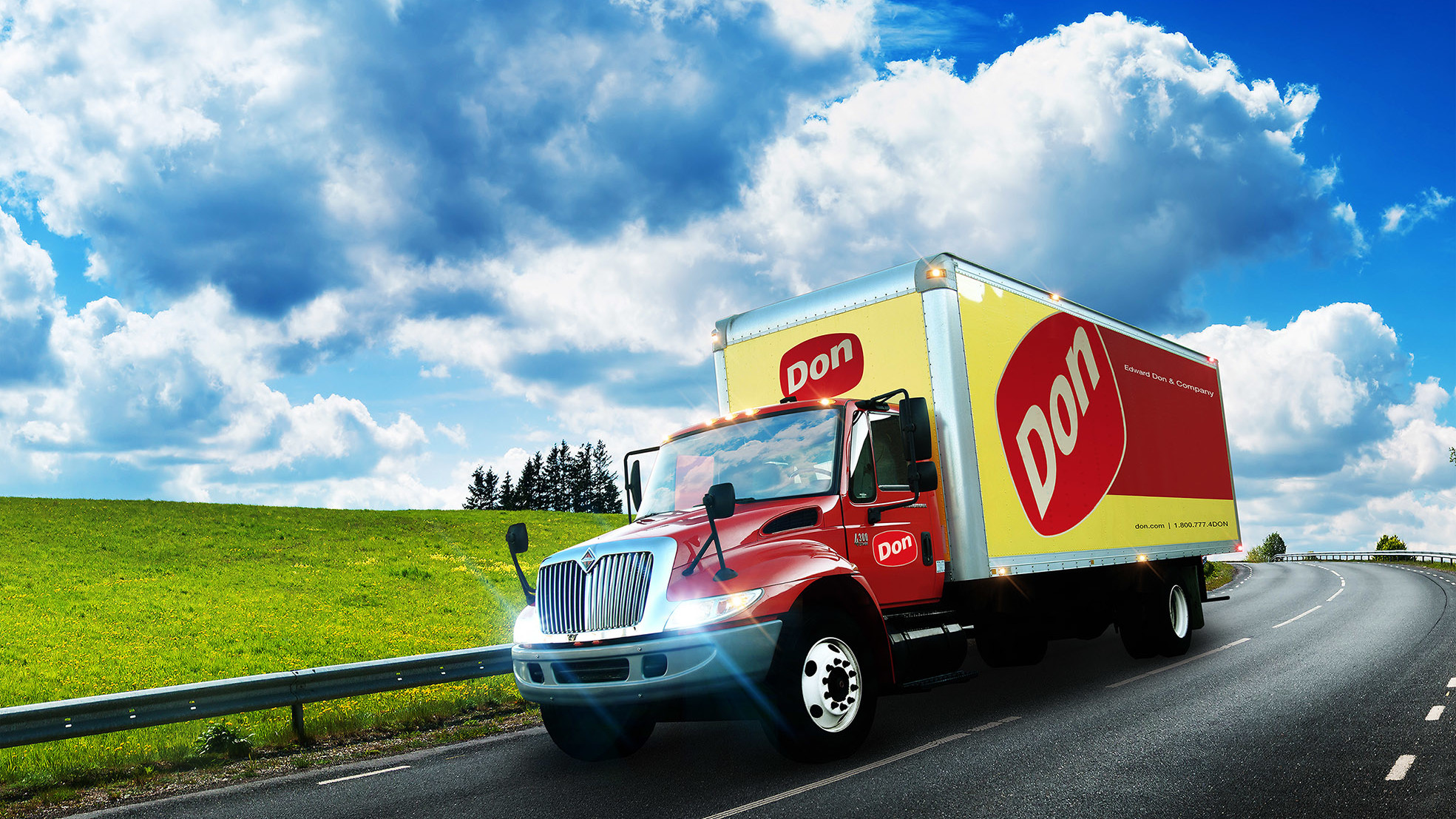 Image of a Don Edwards truck on a highway with cloud spun blue skies.