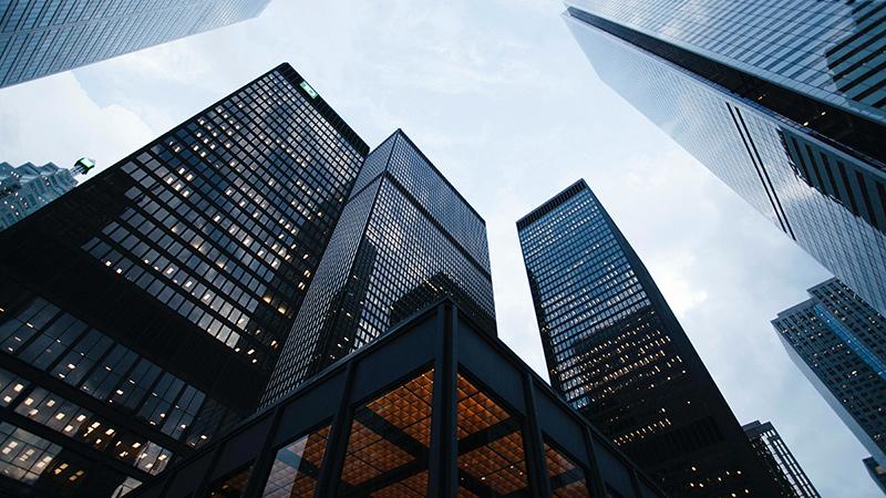 A cluster of skyscrapers, as seen from the ground.