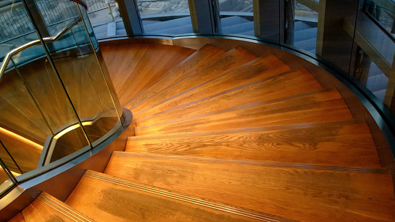 A spiral staircase, with wooden risers.