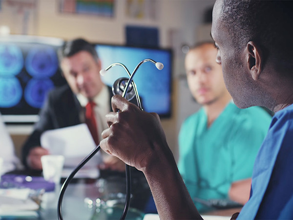 Medical professionals seated around a conference table.