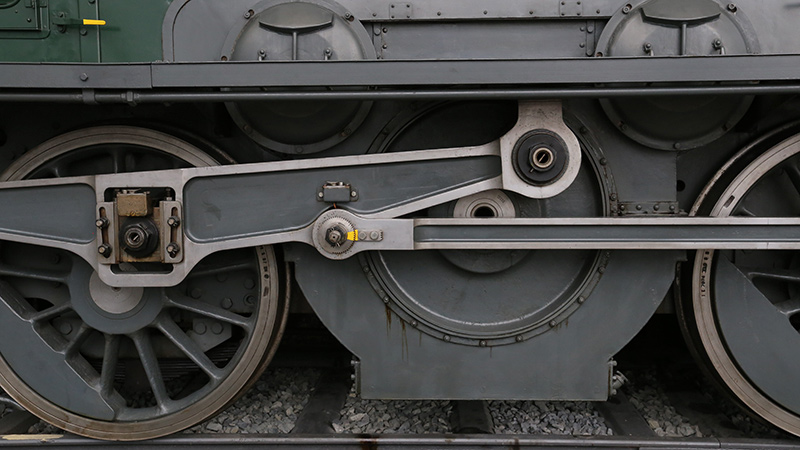 A close up of locomotive wheels.