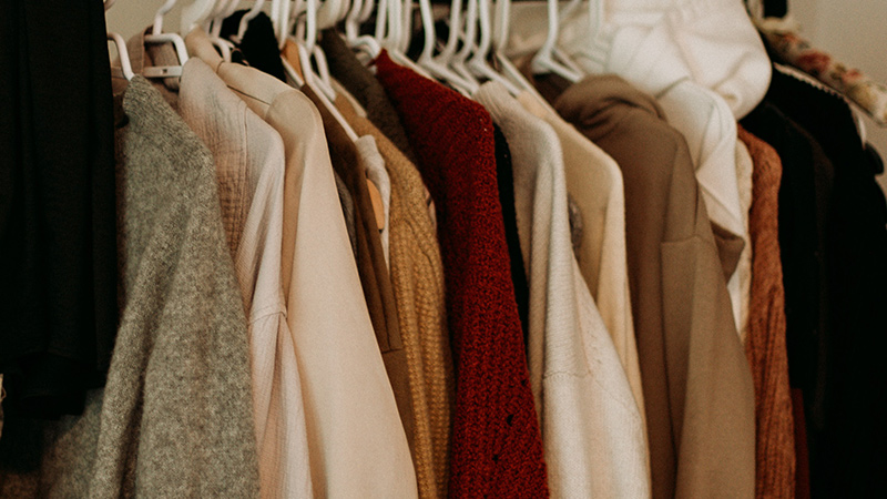 Clothes hanging in a closet.