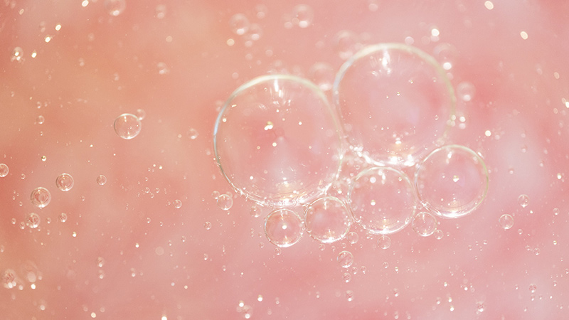 Soapy bubbles on top of liquid.
