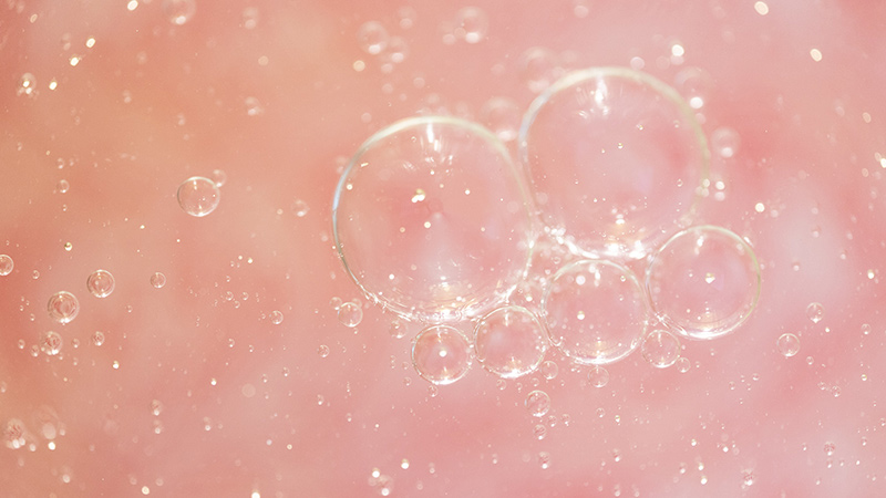 Soapy bubbles on top of liquid.