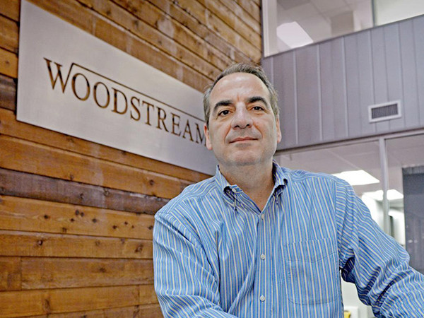 Man in front of a Woodstream banner.