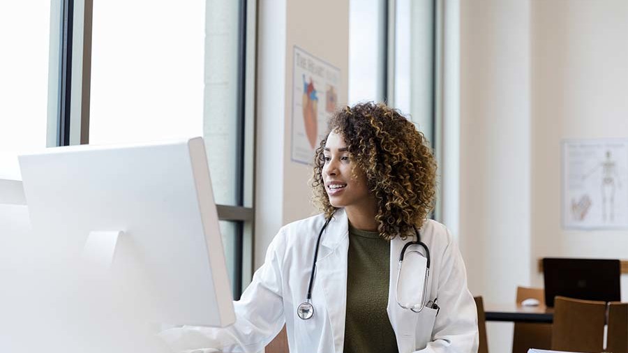 Healthcare worker at a monitor.