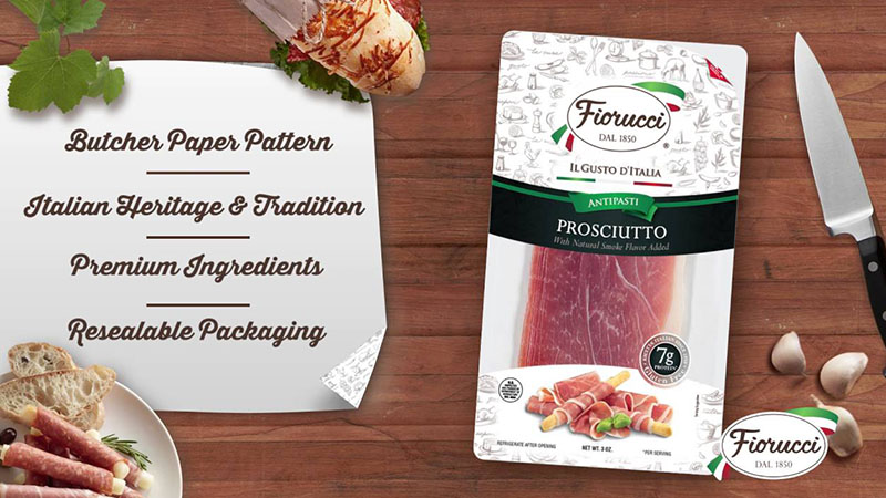 A package of Fiorucci prosciutto on a butcher block with a sandwich, and a chef's knife.